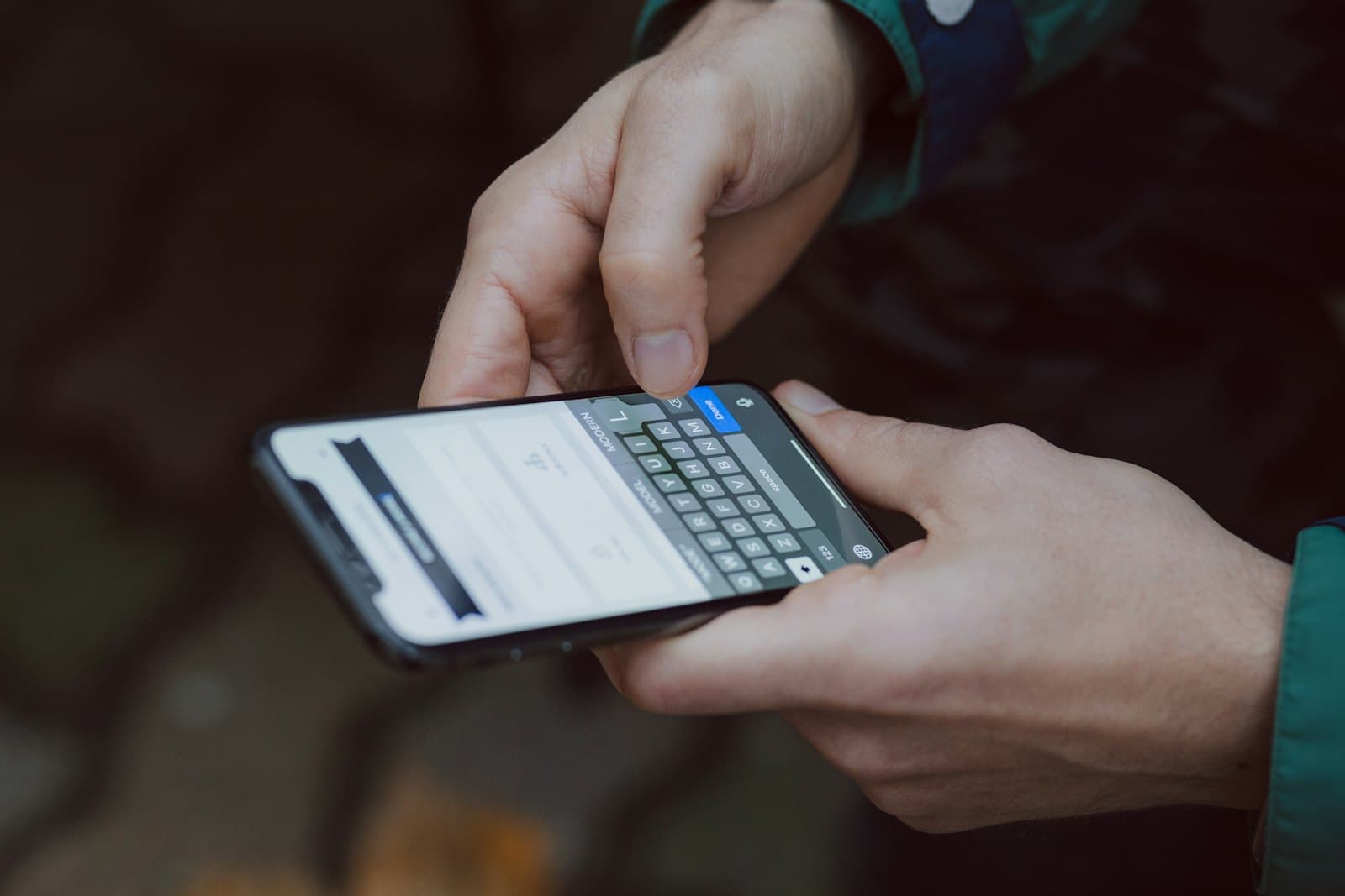 Hands typing on a smartphone