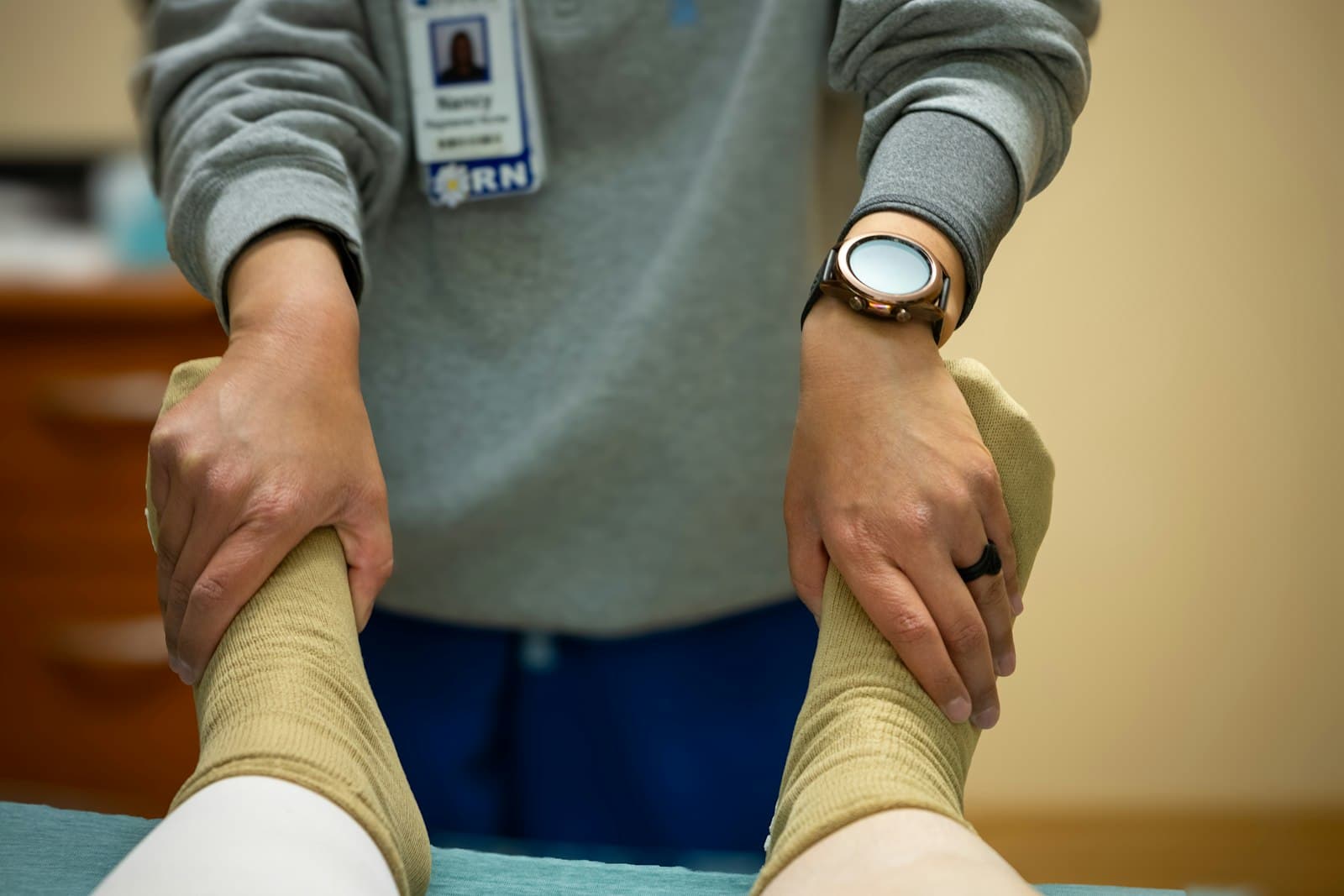 Sports medicine professional examining a patient's taped ankles