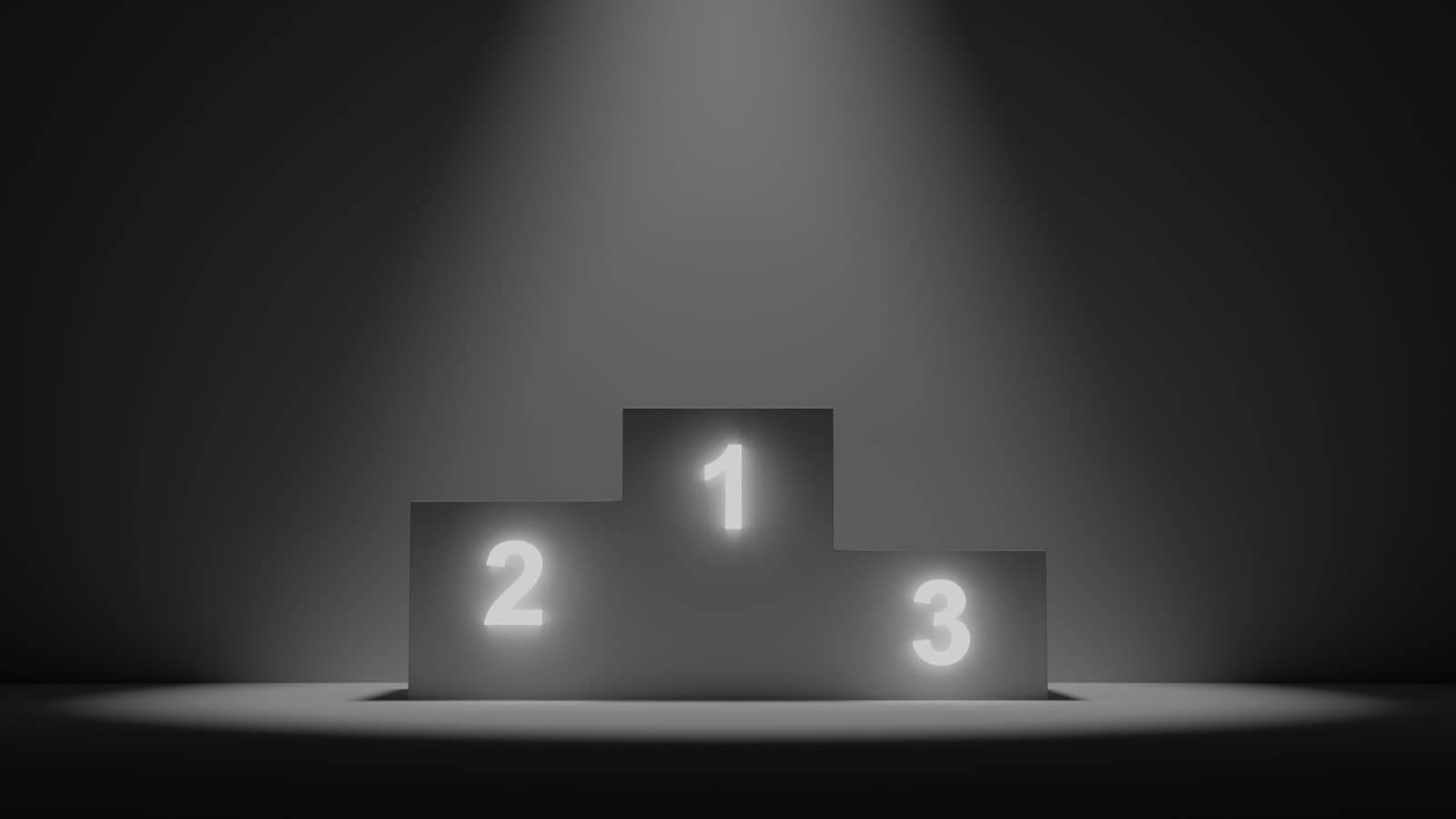 Spotlit podium with first, second, and third place platforms