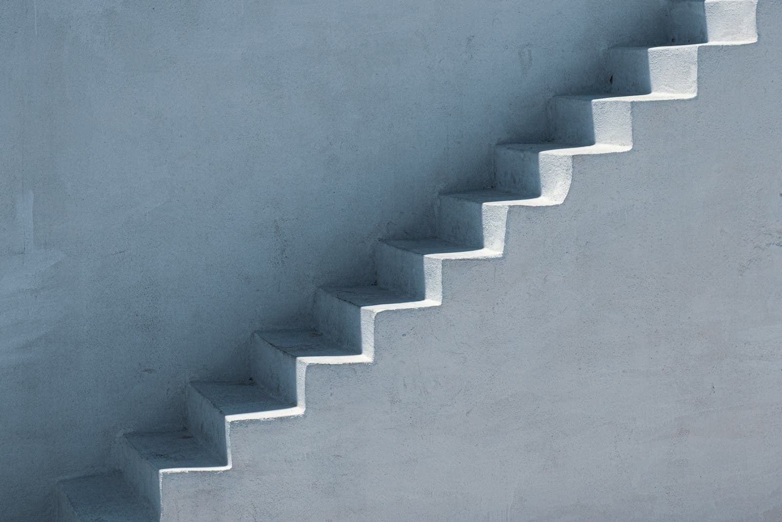 White concrete staircase descending in even steps