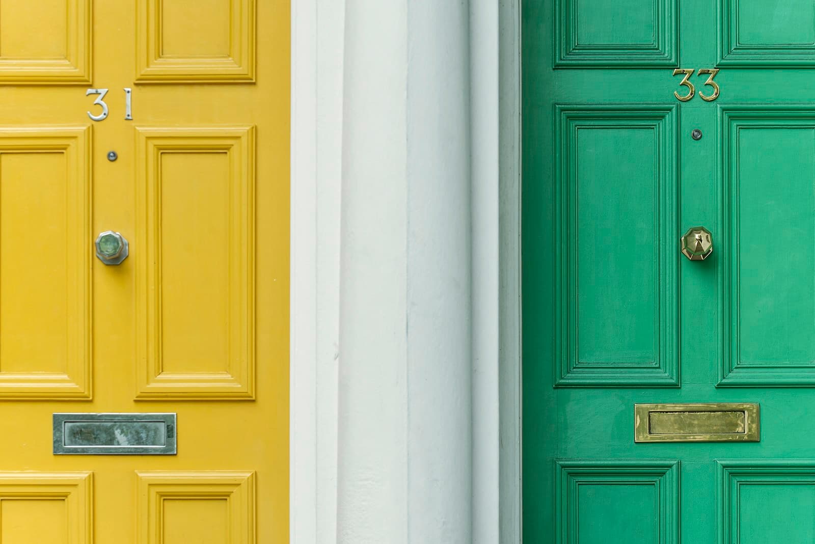A yellow front door and a green front door side by side