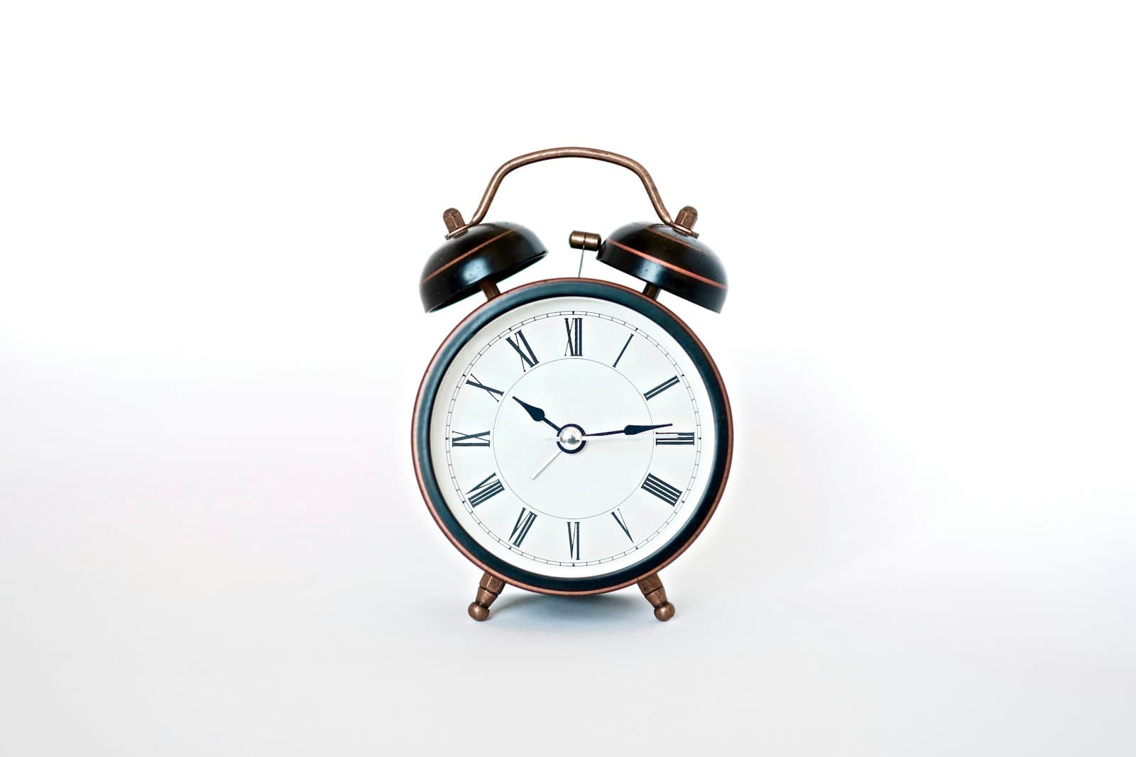 Vintage twin-bell alarm clock on a white background